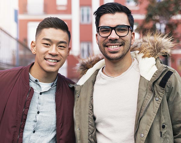 two young men friends outside city